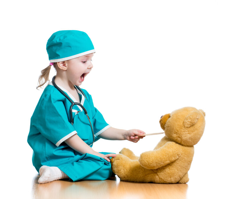 Adorable,Child,Dressed,As,Doctor,Playing,With,Toy,Over,White